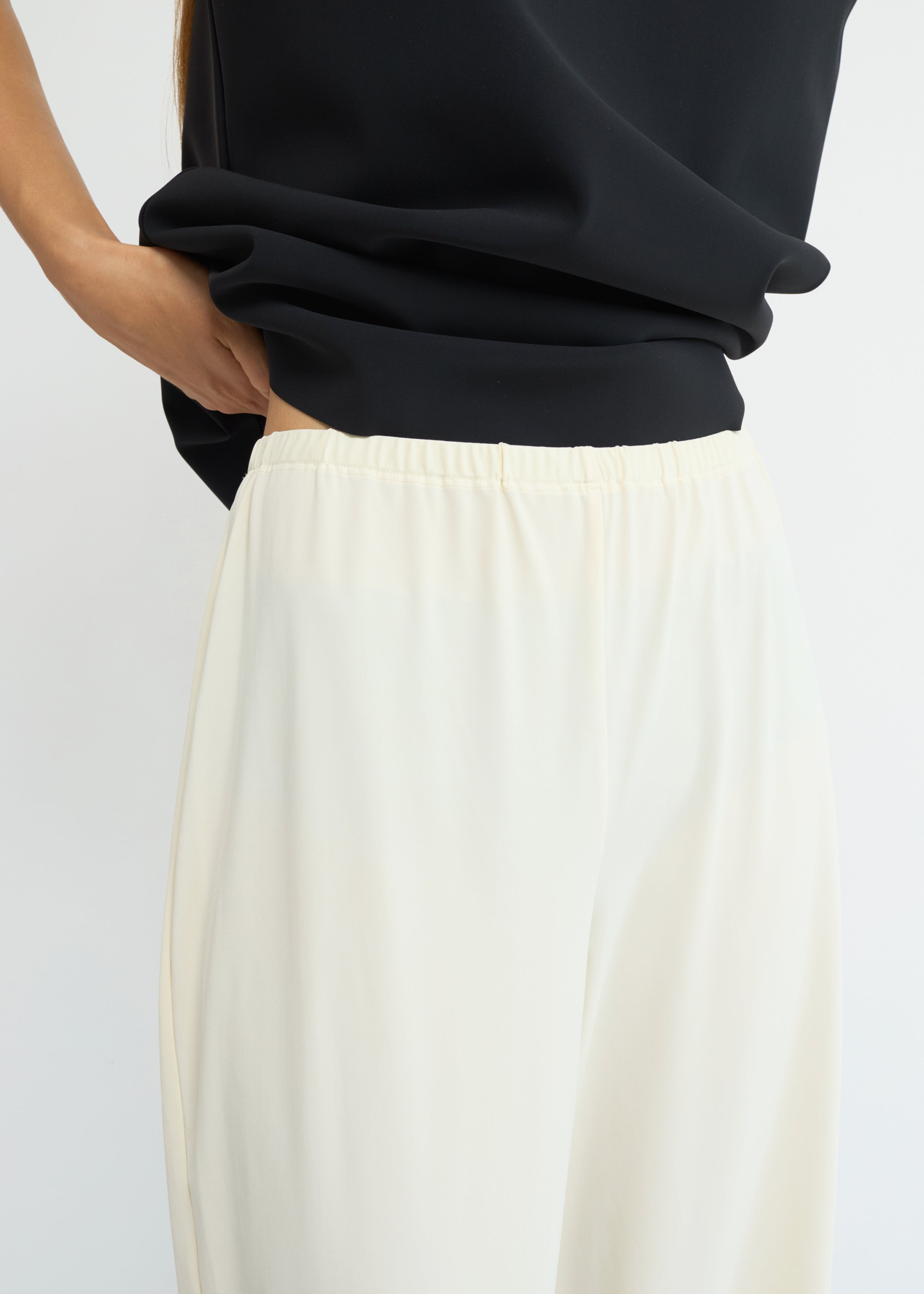 Cream wide-leg jersey pants with a fluid silhouette and elasticated waistband